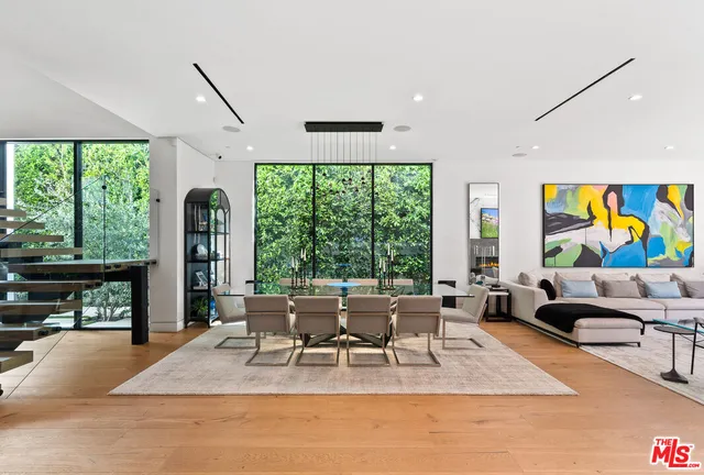 a large white kitchen with a large window