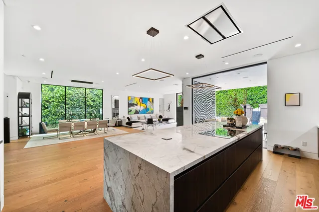 a kitchen with stainless steel appliances kitchen island sink stove and refrigerator