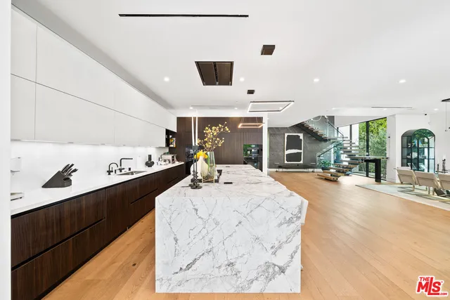 a large kitchen with a table and chairs