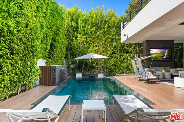 a living room filled with furniture and a potted plant