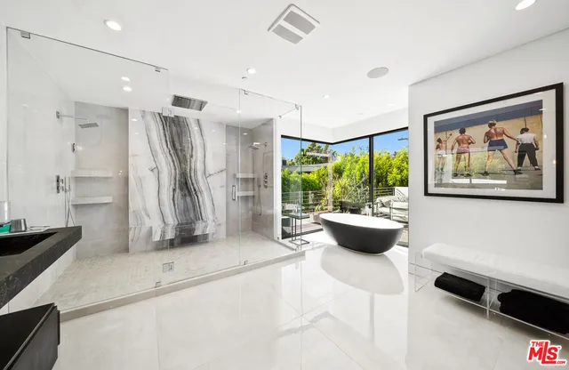 a very nice looking room with a large window and a potted plant