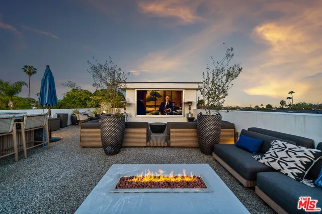 a living room with patio furniture and a fireplace