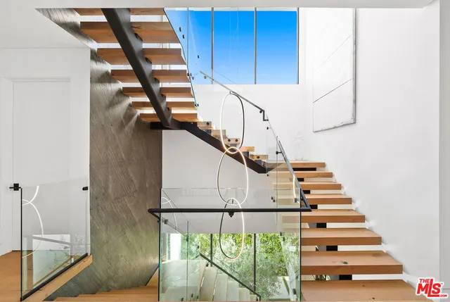 a living room with patio furniture and a potted plants