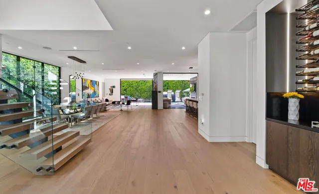 a living room with furniture and large windows