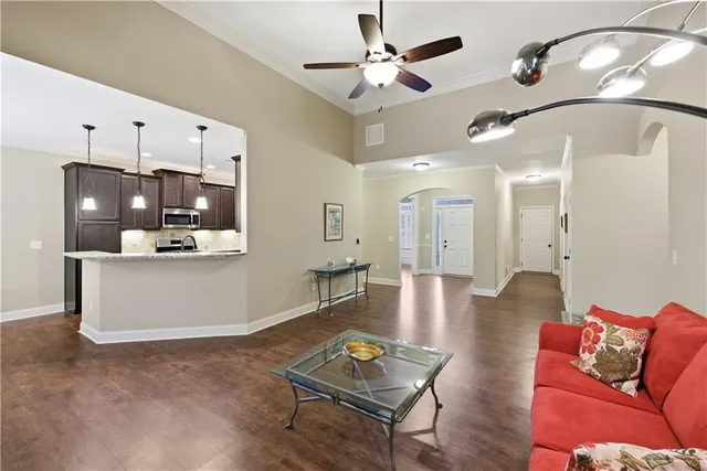 a living room with furniture and wooden floor