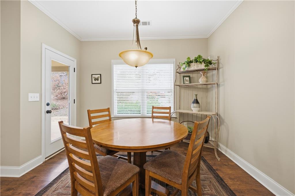 308 Morning Frost Canton, GA 30114 - Photo 13 of 41 a dining room with furniture a chandelier and wooden floor