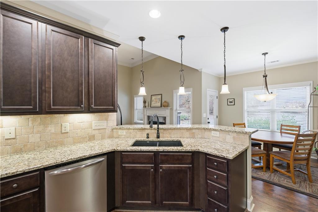 308 Morning Frost Canton, GA 30114 - Photo 19 of 41 a kitchen with granite countertop a sink a counter space appliances and cabinets