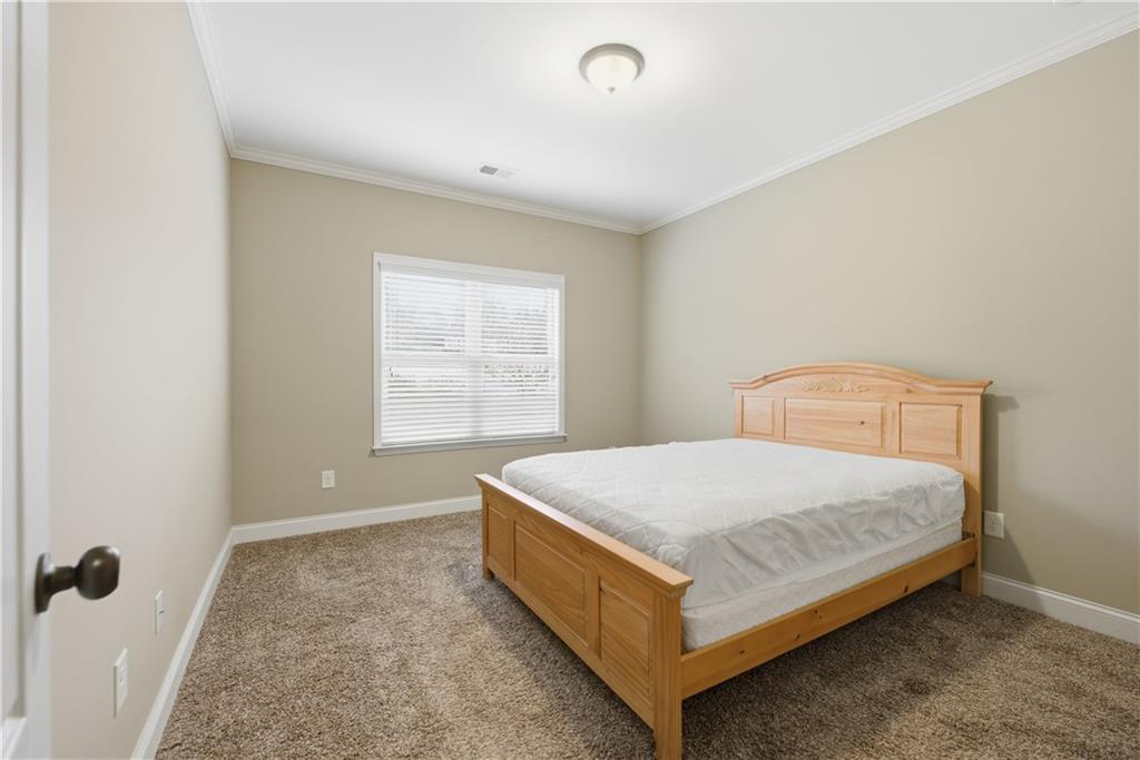 308 Morning Frost Canton, GA 30114 - Photo 23 of 41 a bedroom with a bed and window