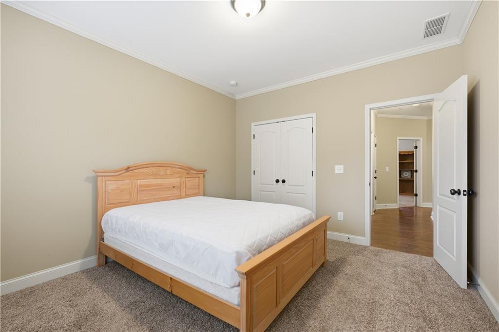 308 Morning Frost Canton, GA 30114 - Photo 24 of 41 a bedroom with a bed and closet