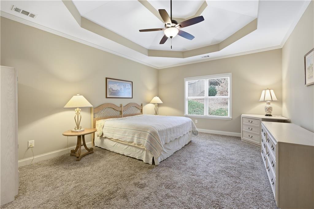 308 Morning Frost Canton, GA 30114 - Photo 25 of 41 a spacious bedroom with a bed and a table