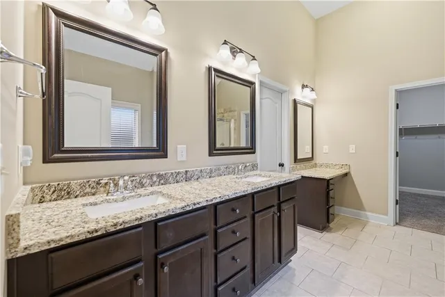 a bathroom with double sink and a mirror