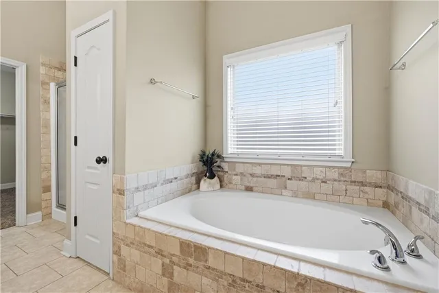 a white bath tub sitting next to a shower
