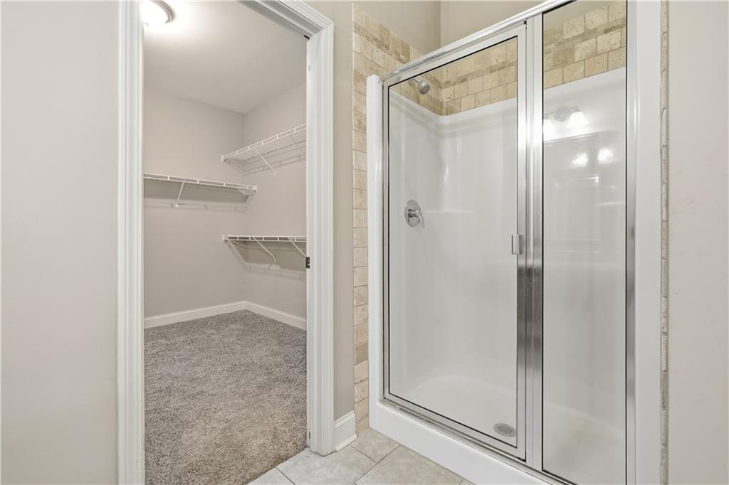 308 Morning Frost Canton, GA 30114 - Photo 29 of 41 a bathroom with a glass shower door