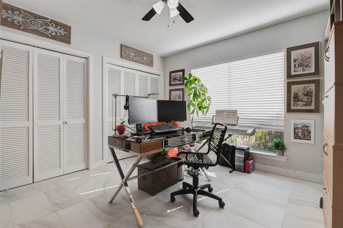 2234 South Piney Point Road, Unit 110 Houston, TX 77063 - Photo 13 of 25 Secondary bedroom that is used as home office at this moment. Large windows and sleek tile flooring makes the space bright and stylish