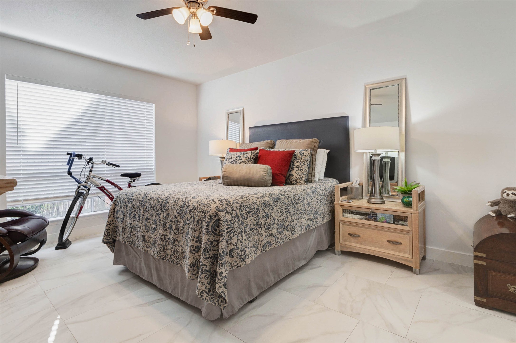 2234 South Piney Point Road, Unit 110 Houston, TX 77063 - Photo 17 of 25 Cozy design with a large window allowing natural light, tiled flooring, and a ceiling fan.