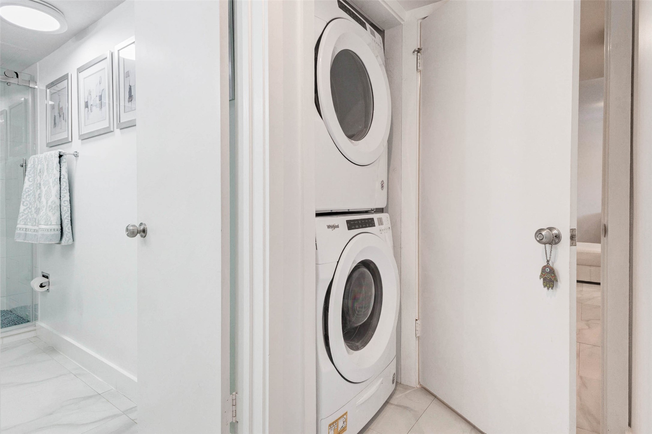 2234 South Piney Point Road, Unit 110 Houston, TX 77063 - Photo 20 of 25 Laundry area with a stacked washer and dryer set in a small closet.