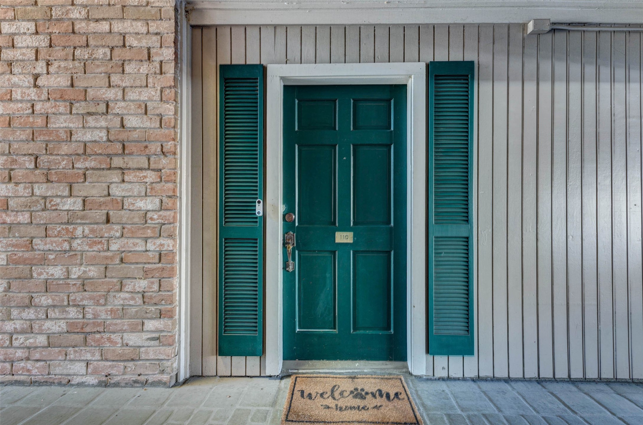 2234 South Piney Point Road, Unit 110 Houston, TX 77063 - Photo 6 of 25 Dark green door framed by matching shutters. creating a cozy and inviting entryway. The key could not be copied.