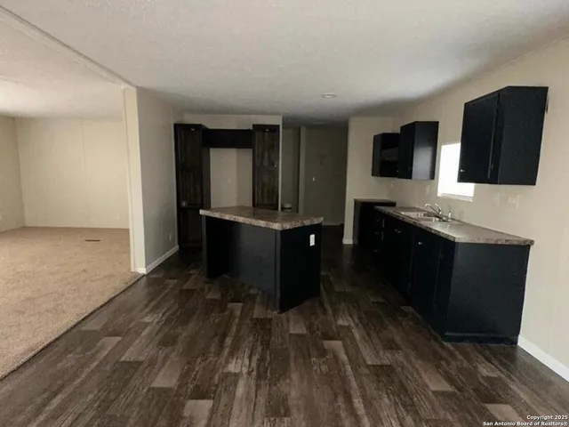 a kitchen with a sink and a microwave