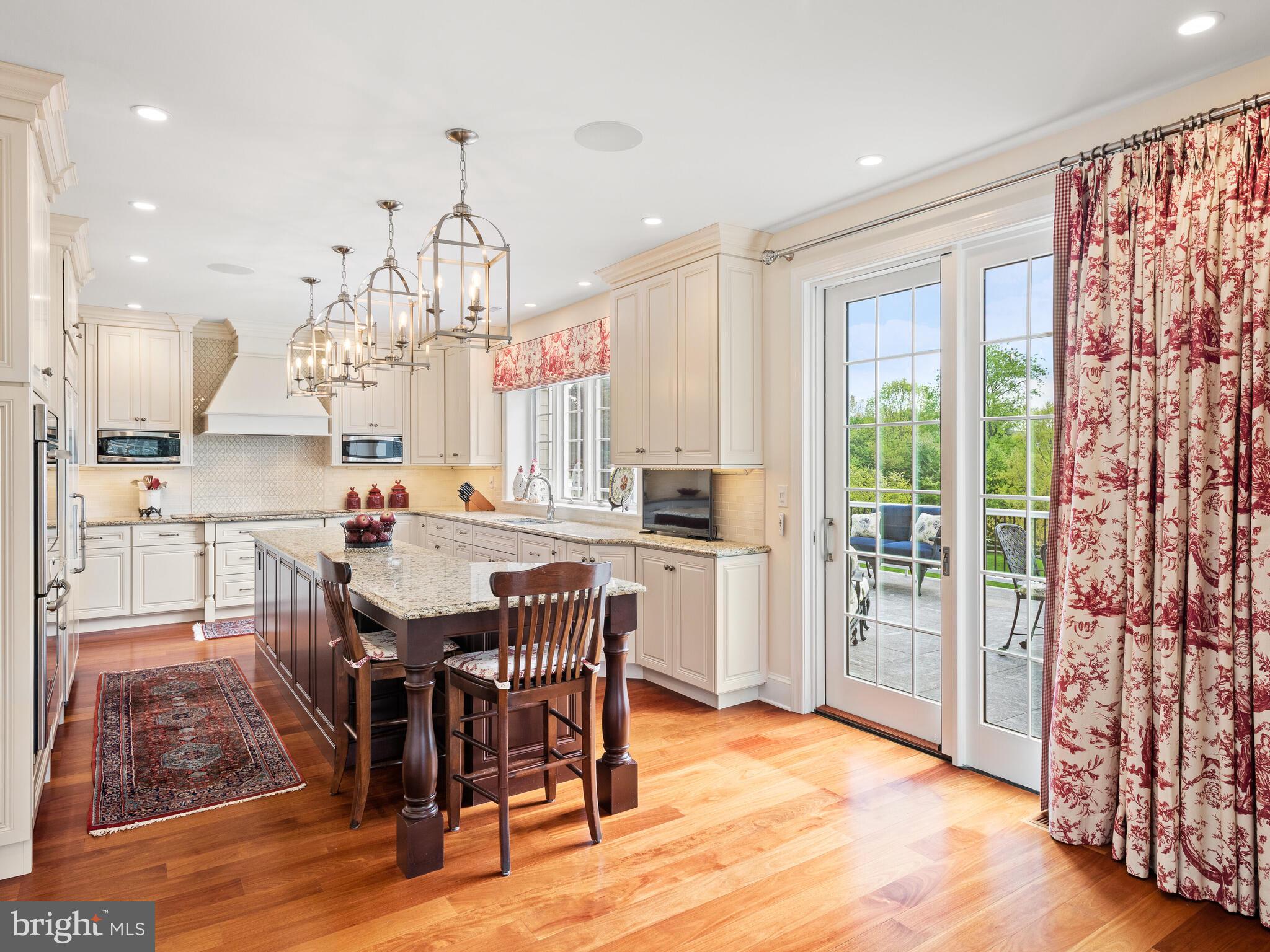 1 Hedgerow Lane Devon, PA 19333 - Photo 15 of 71 Newer slider to back deck from kitchen