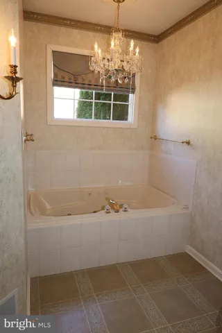 a bathroom with a bathtub and shower