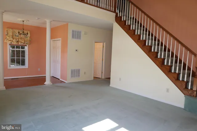 a view of an empty room with stairs