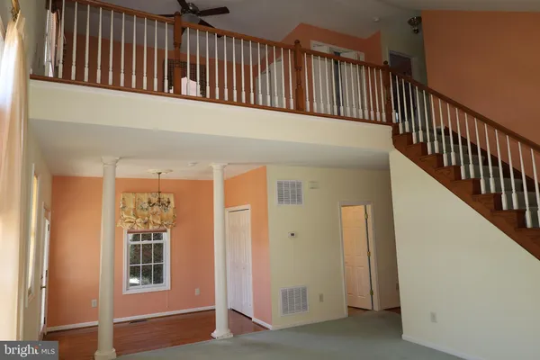 a view of an empty room with stairs