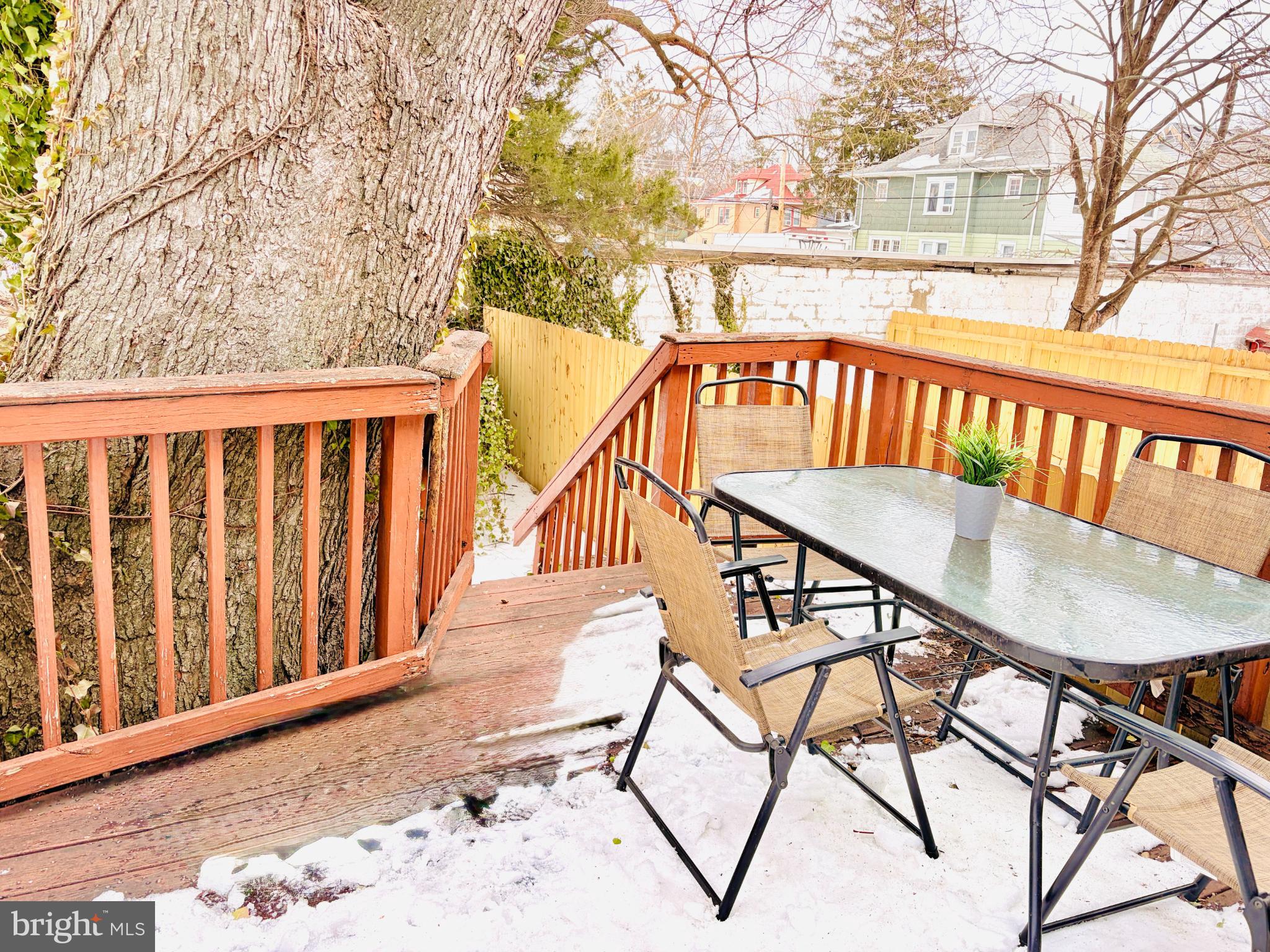 401 Holly Road Yeadon, PA 19050 - Photo 2 of 33 shaded deck nestled by a large tree.