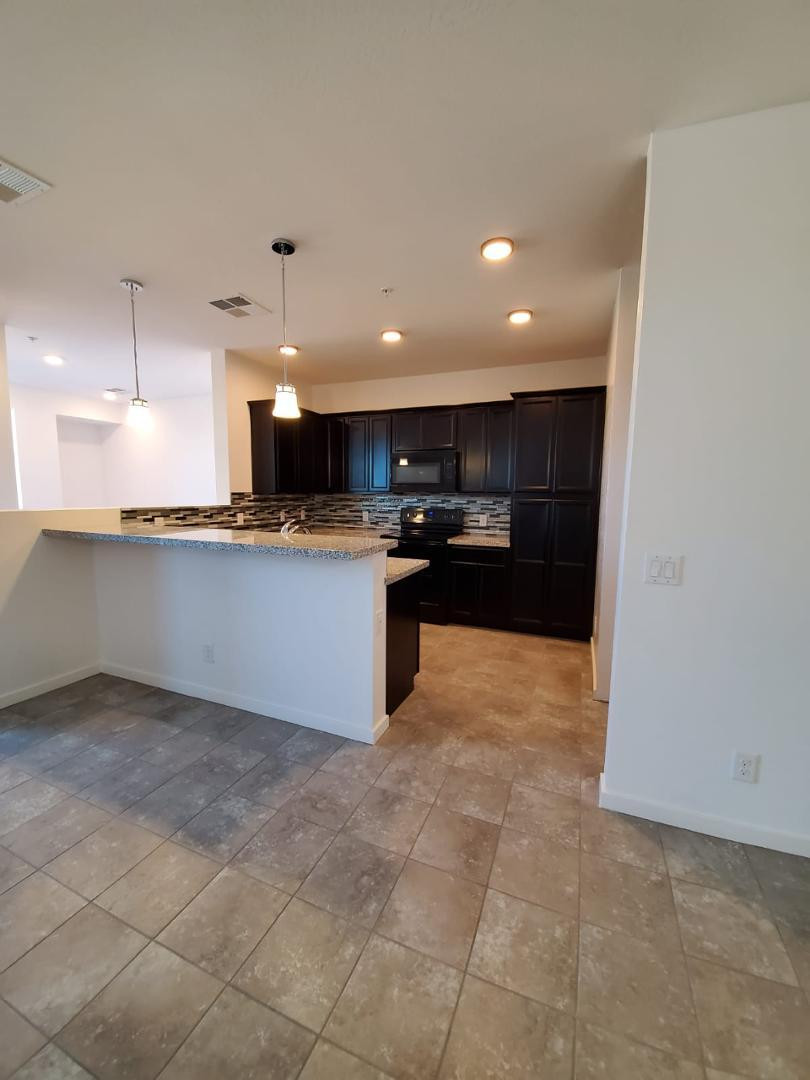 3900 East Baseline Road, Unit 118 Phoenix, AZ 85042 - Photo 30 of 32 a kitchen with stainless steel appliances granite countertop a refrigerator and a sink