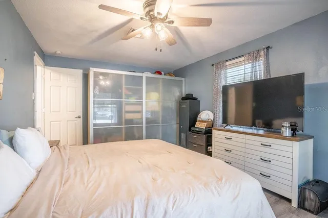 a bedroom with a bed and a flat screen tv