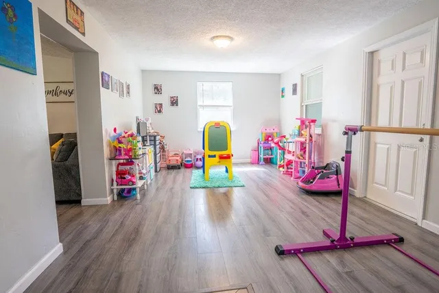 a view of a room with wooden floor and furniture