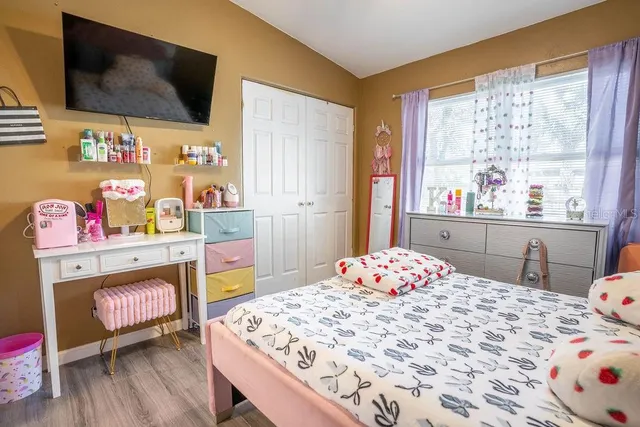 a bedroom with a bed and flat screen tv