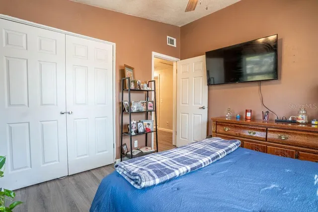 a bedroom with a bed and flat screen tv