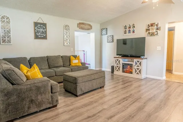 a living room with furniture and a flat screen tv