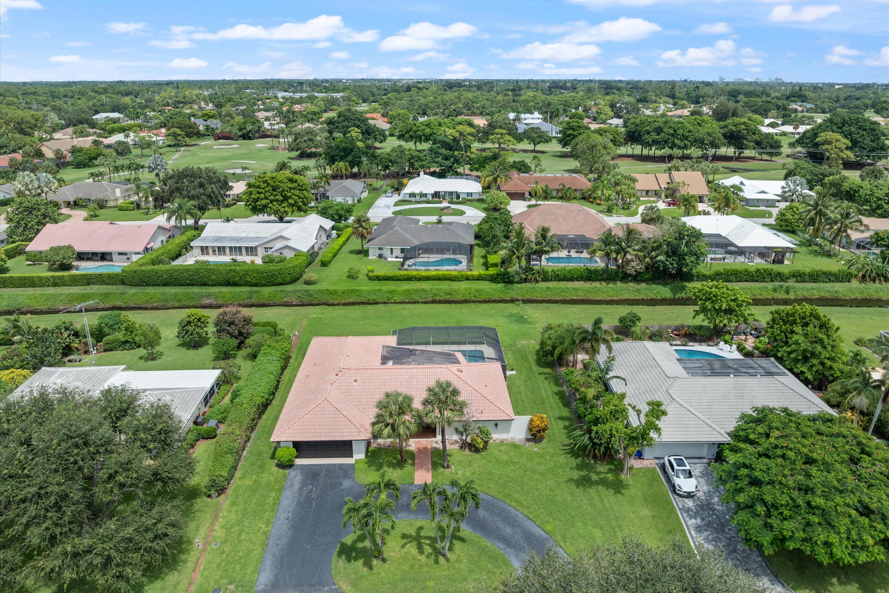 516 Muirfield Drive Atlantis, FL 33462 - Photo 1 of 43 an aerial view of a house with outdoor space and street view
