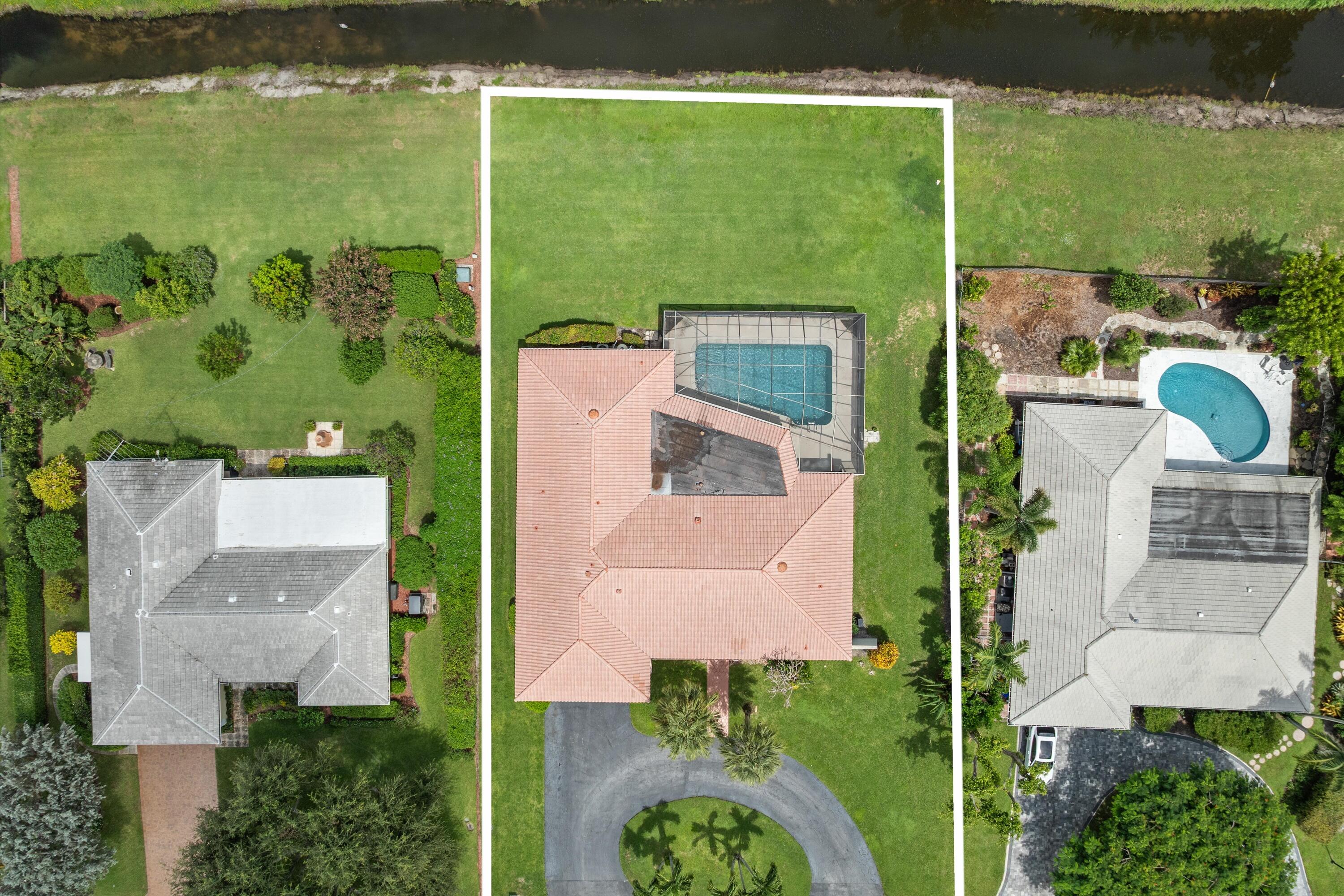 516 Muirfield Drive Atlantis, FL 33462 - Photo 2 of 43 an aerial view of residential houses with outdoor space and swimming pool