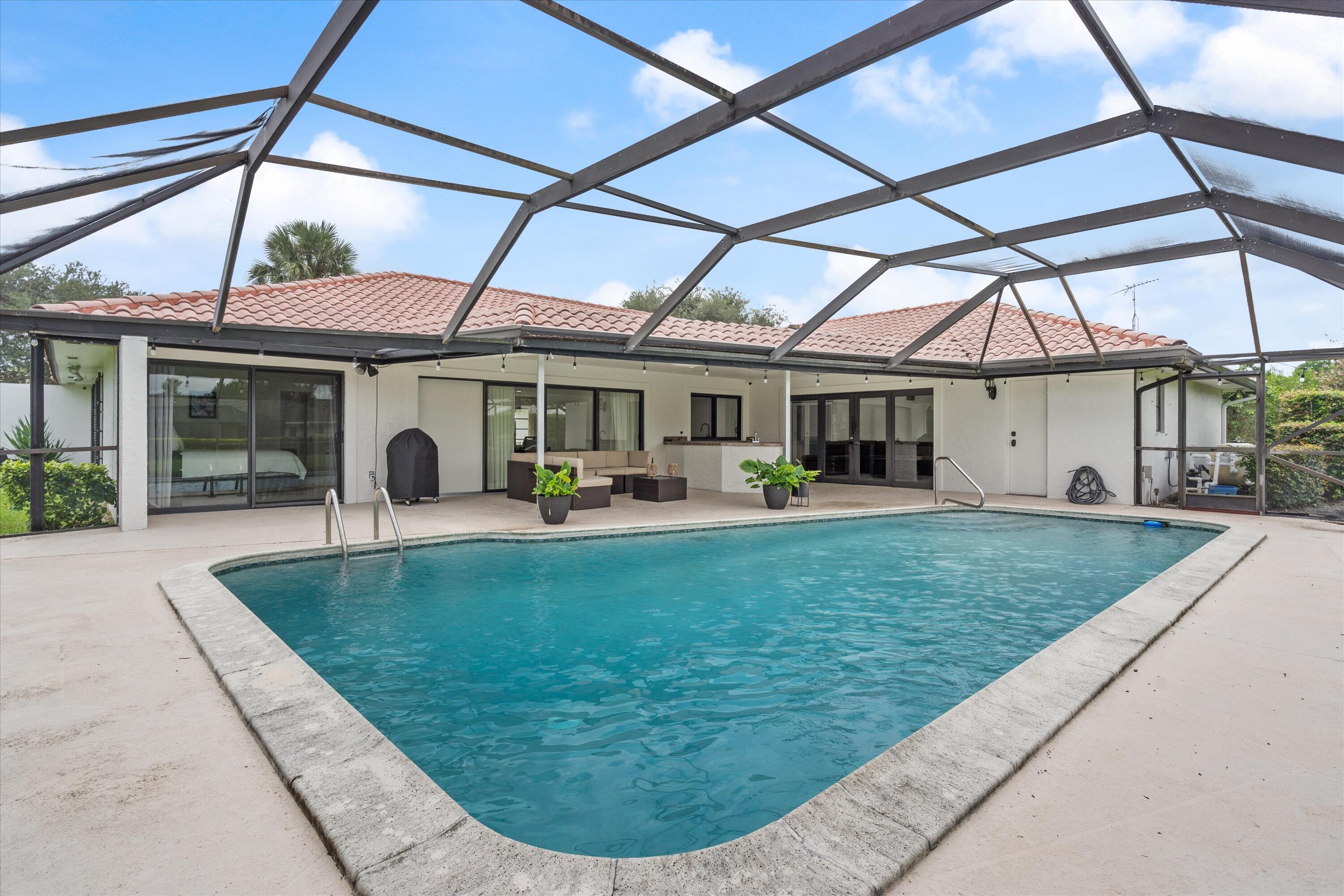 516 Muirfield Drive Atlantis, FL 33462 - Photo 26 of 43 a view of outdoor space yard deck patio and swimming pool