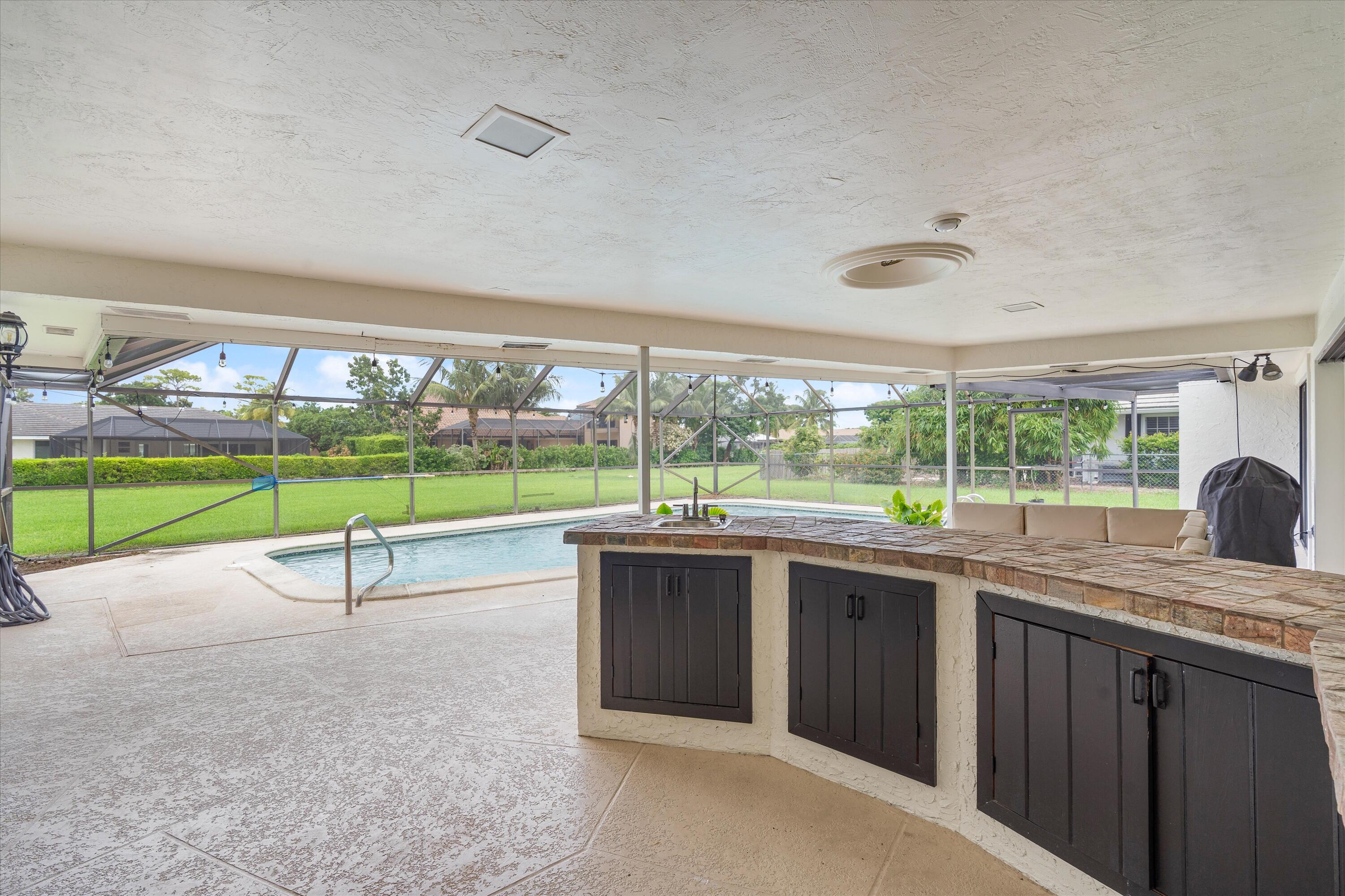 516 Muirfield Drive Atlantis, FL 33462 - Photo 30 of 43 a view of a room with a sink and wooden floor