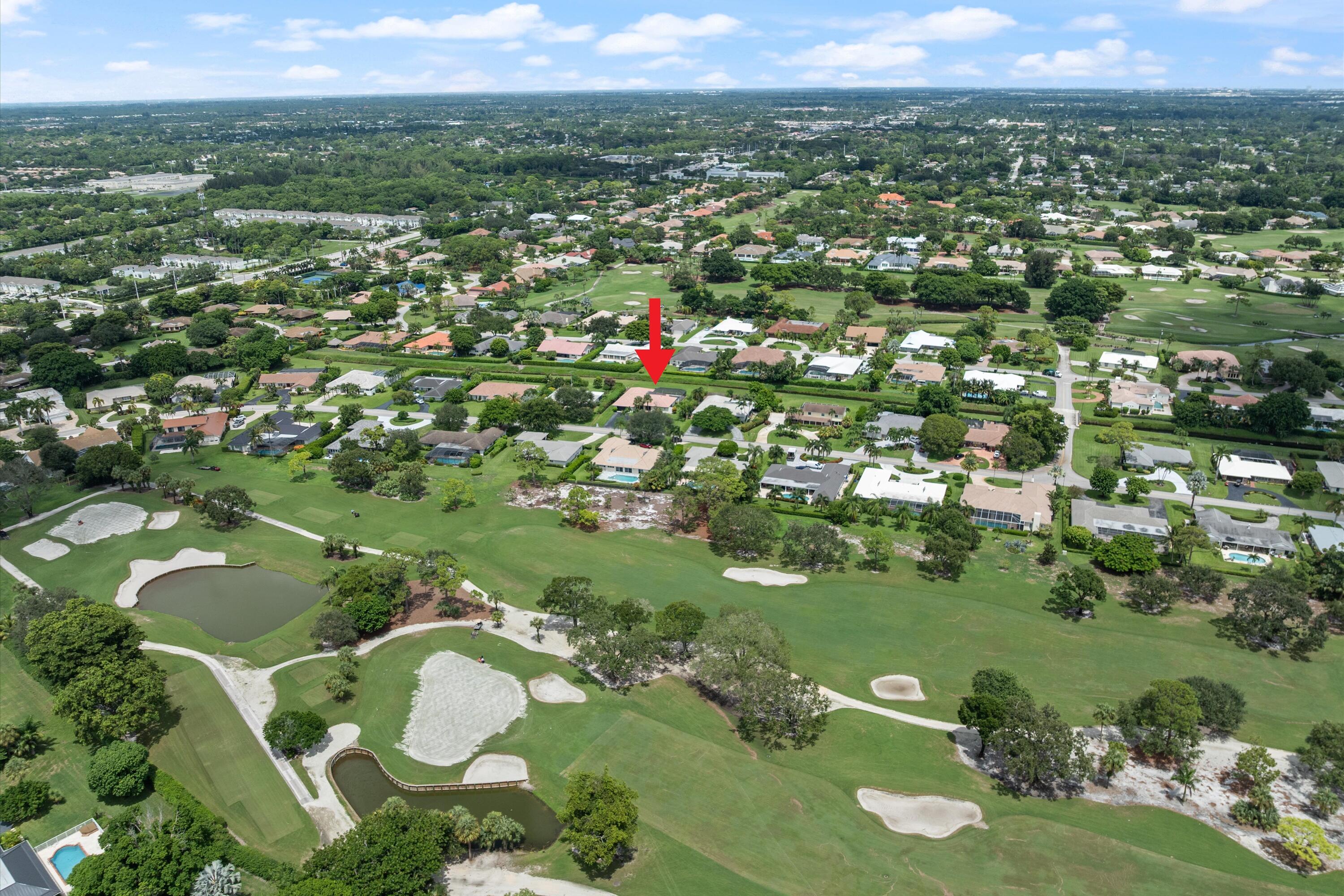 516 Muirfield Drive Atlantis, FL 33462 - Photo 33 of 43 a view of a lake with a city