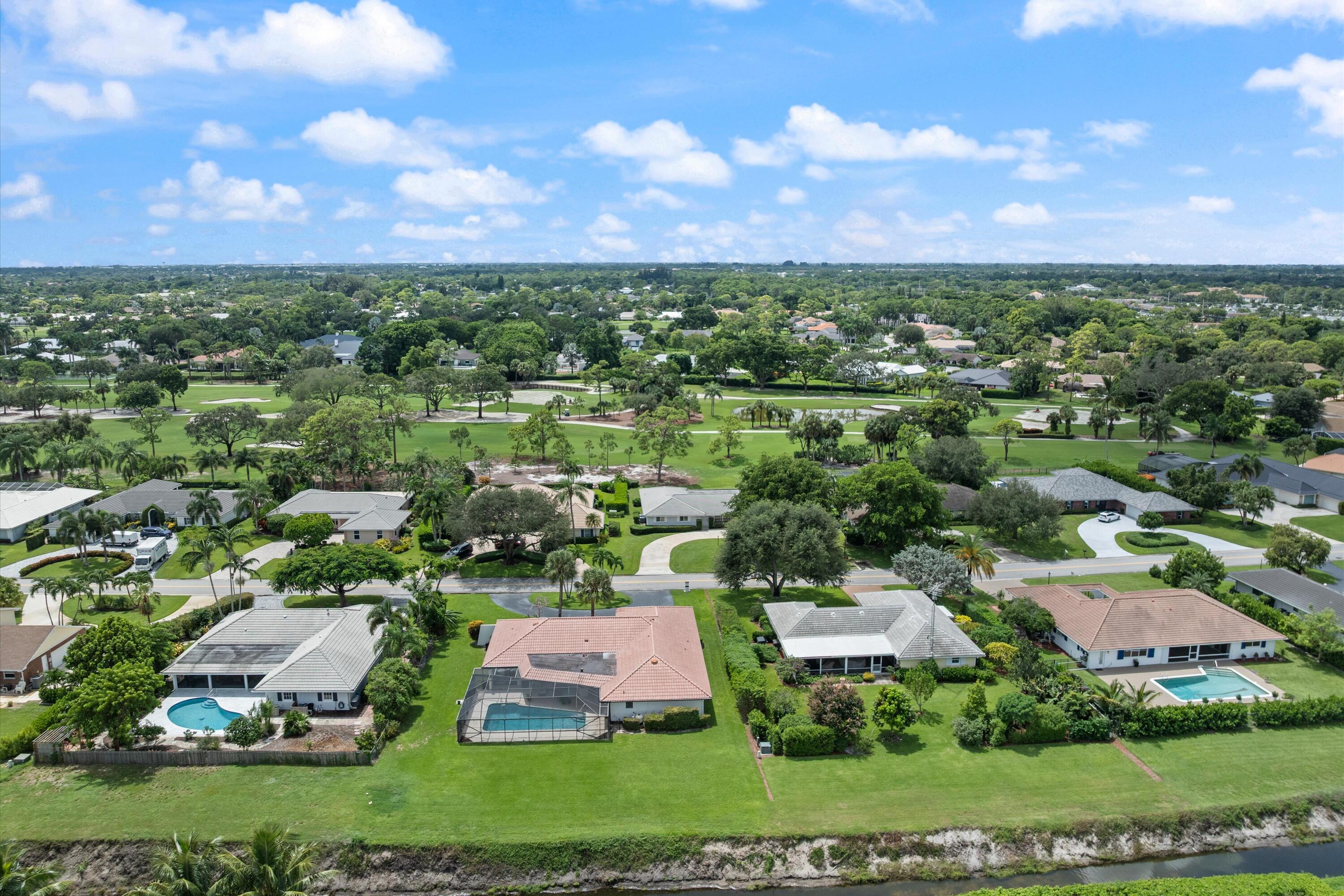 516 Muirfield Drive Atlantis, FL 33462 - Photo 43 of 43 an aerial view of residential houses with outdoor space and trees