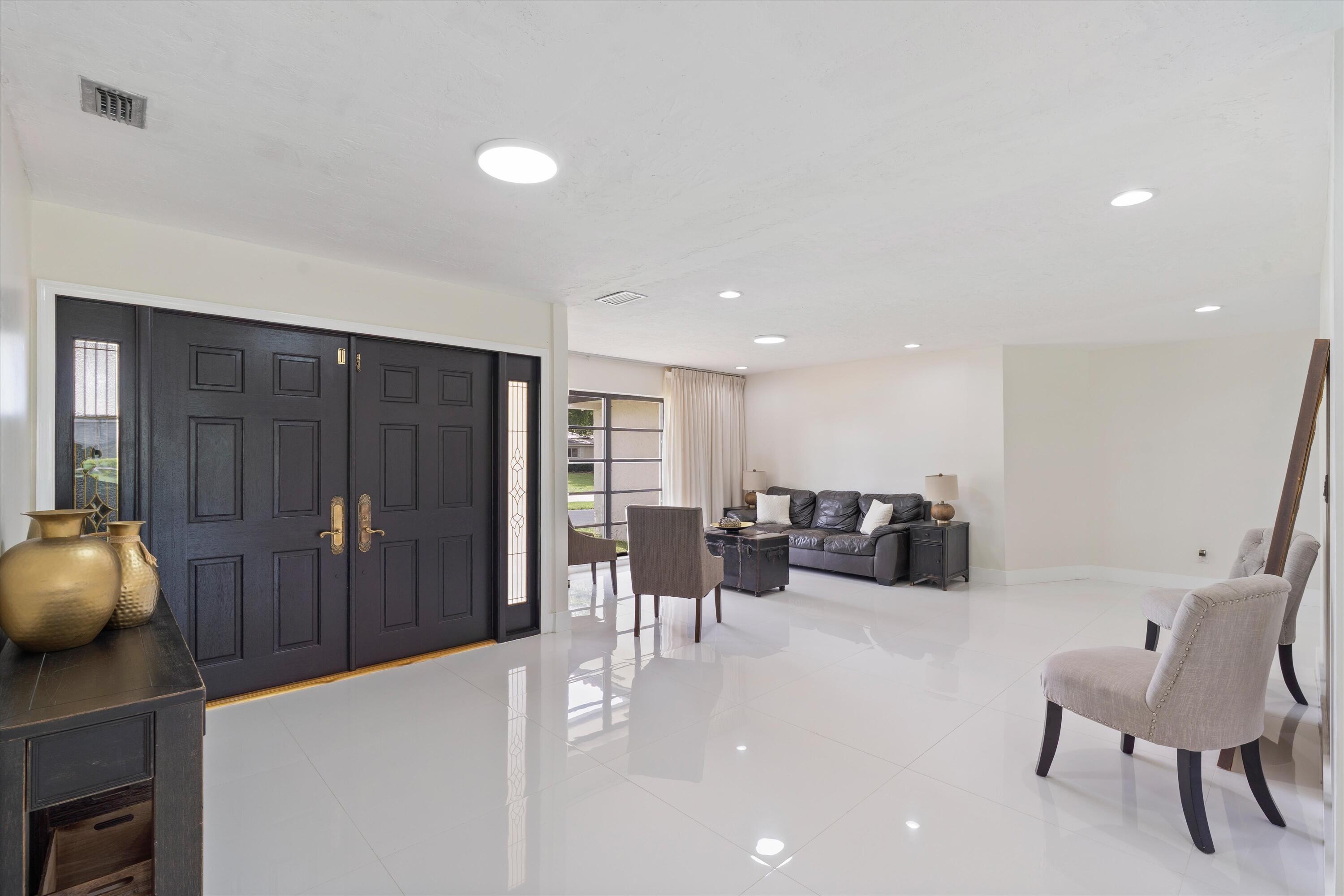 516 Muirfield Drive Atlantis, FL 33462 - Photo 6 of 43 a view of a livingroom with furniture and a couch