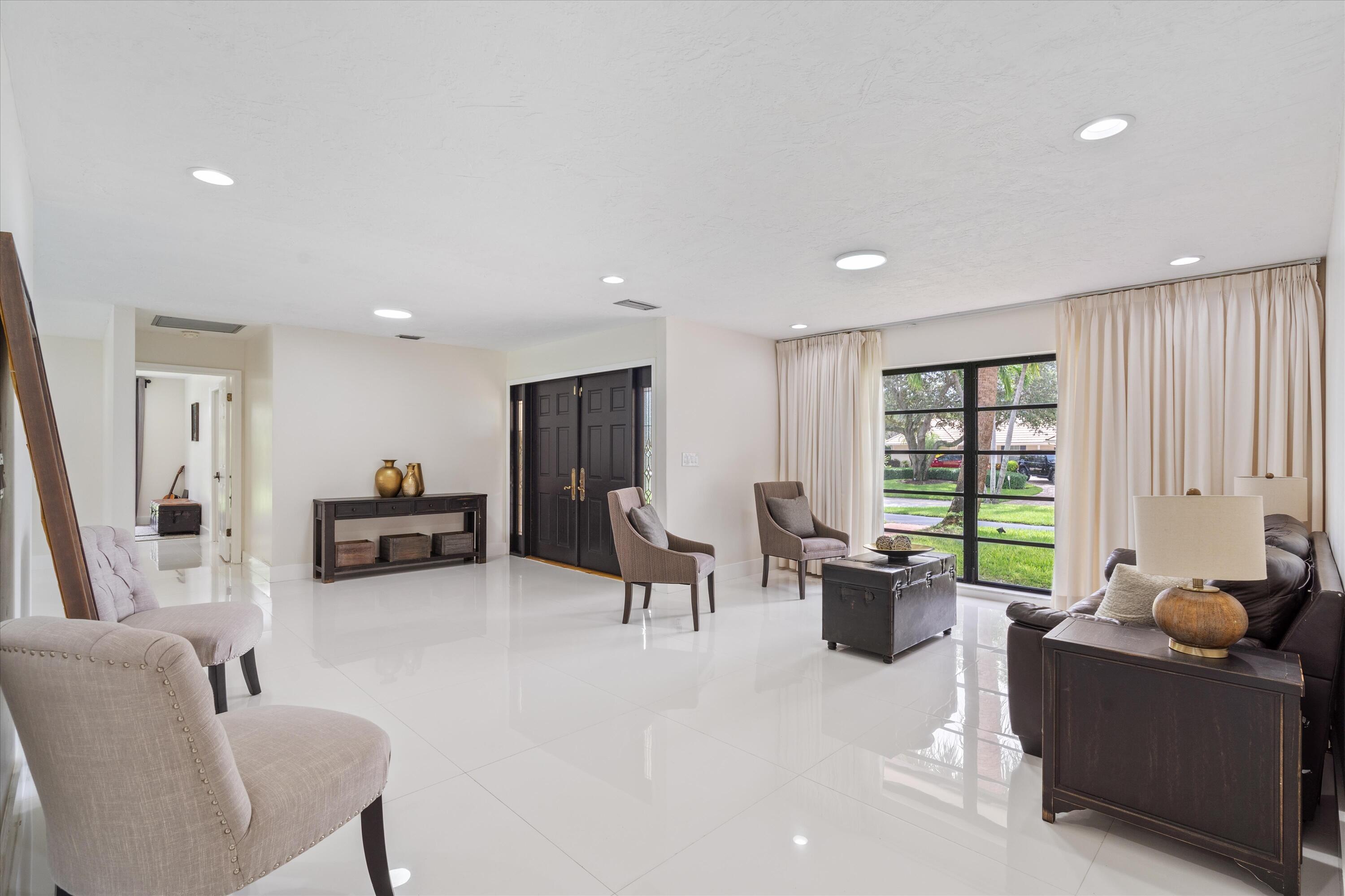 516 Muirfield Drive Atlantis, FL 33462 - Photo 7 of 43 a living room with furniture and a window