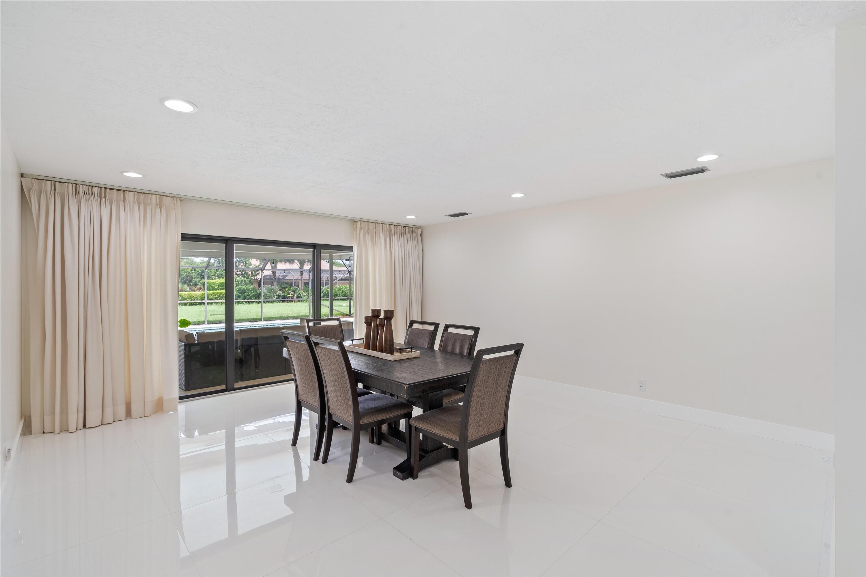 516 Muirfield Drive Atlantis, FL 33462 - Photo 8 of 43 a view of a dining room with furniture and window