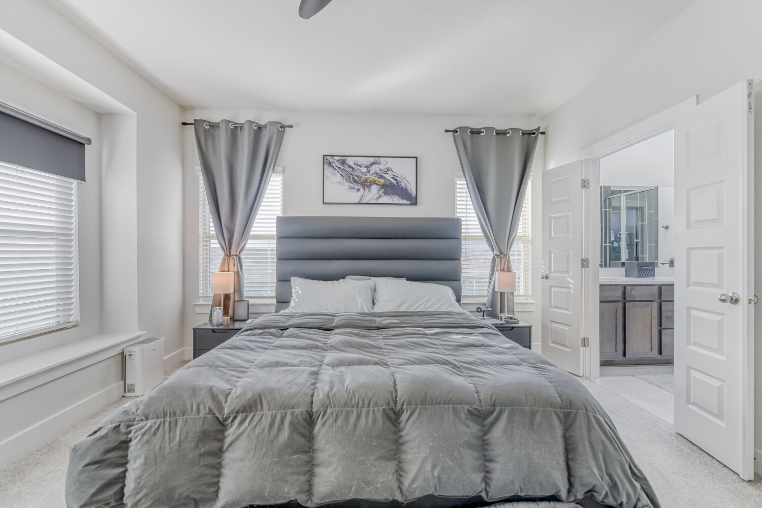 504 Spinnaker Loop Kyle, TX 78640 - Photo 7 of 17 Bedroom featuring light colored carpet, connected bathroom, and a ceiling fan
