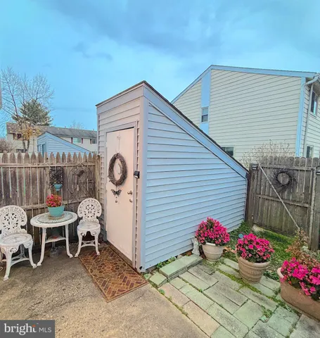 a view of a chairs and table in backyard