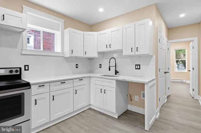 a kitchen with white cabinets and white appliances