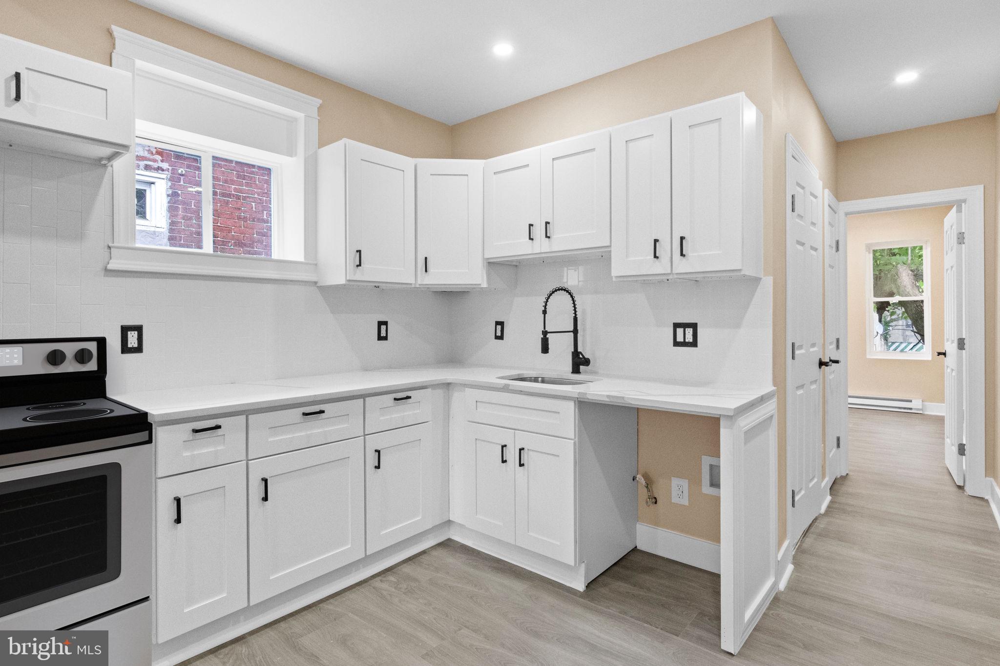 a kitchen with white cabinets and white appliances