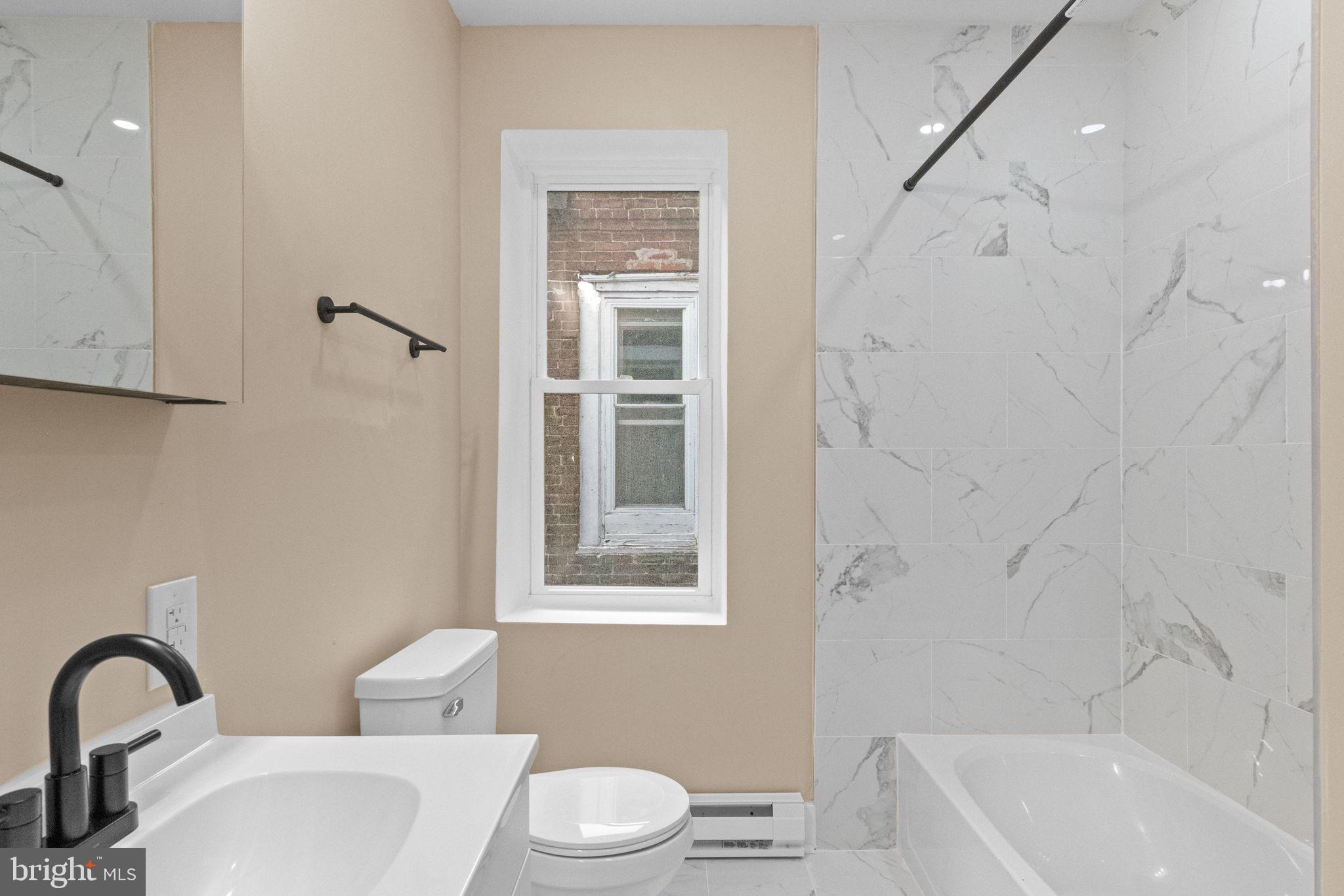 2839 North 9th Street, Unit 1 Philadelphia, PA 19133 - Photo 11 of 19 a bathroom with a toilet a sink and bathtub