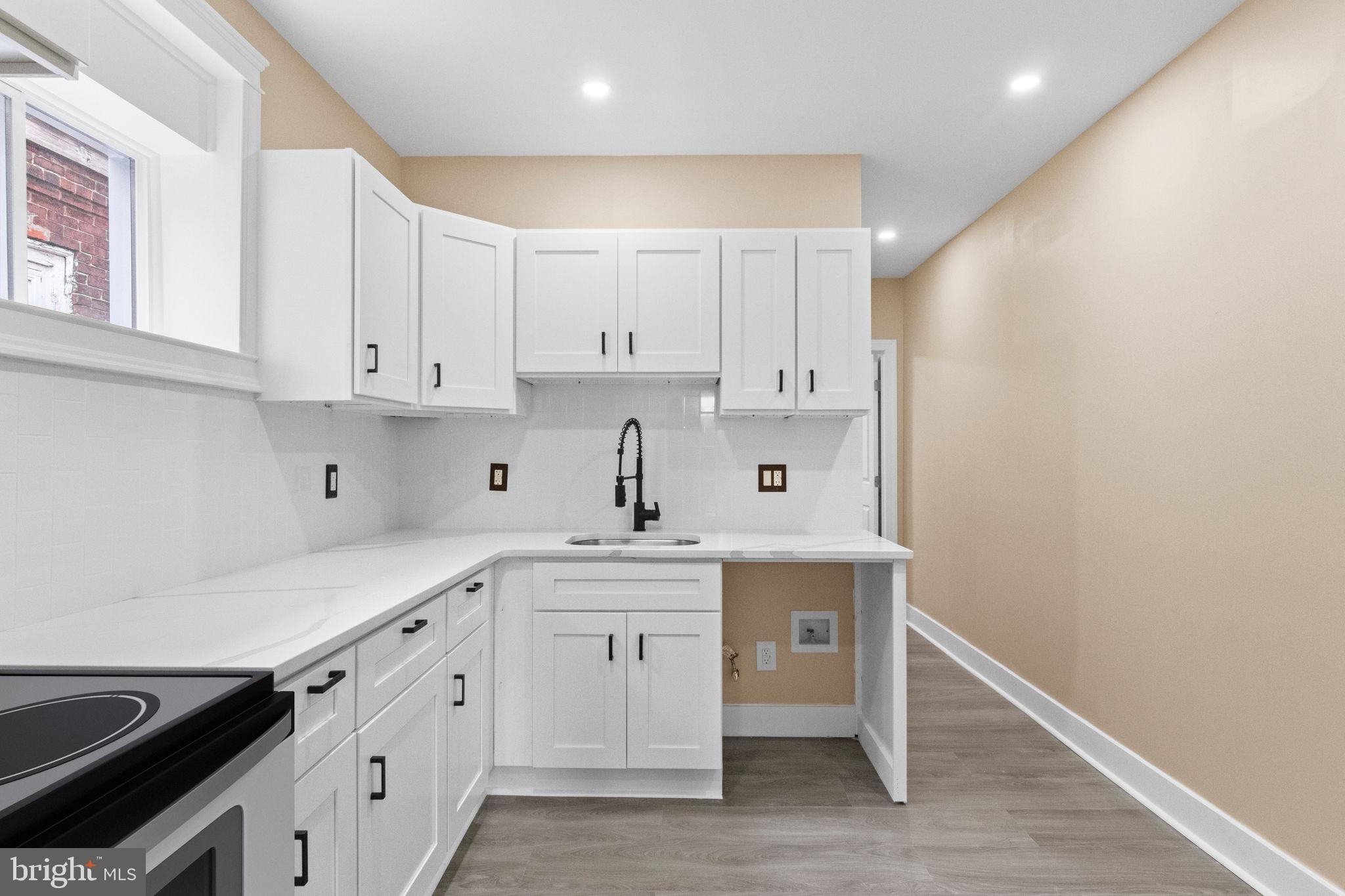 2839 North 9th Street, Unit 1 Philadelphia, PA 19133 - Photo 5 of 19 a kitchen with stainless steel appliances white cabinets and sink