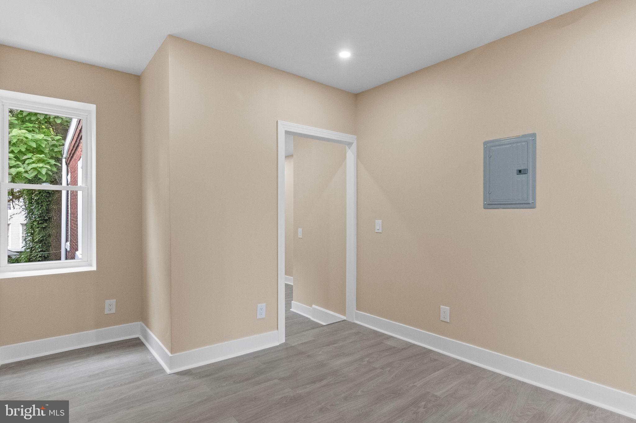 2839 North 9th Street, Unit 1 Philadelphia, PA 19133 - Photo 7 of 19 an empty room with wooden floor and windows