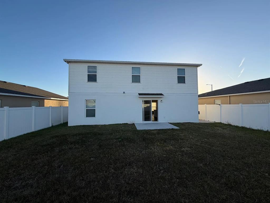 673 Hillview Loop Haines City, FL 33844 - Photo 13 of 14 a backyard of a house with table and chairs